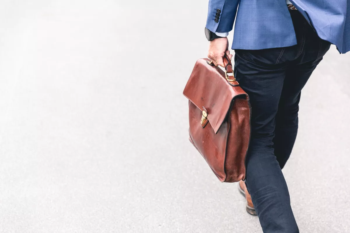 man holding a bag walking in the street